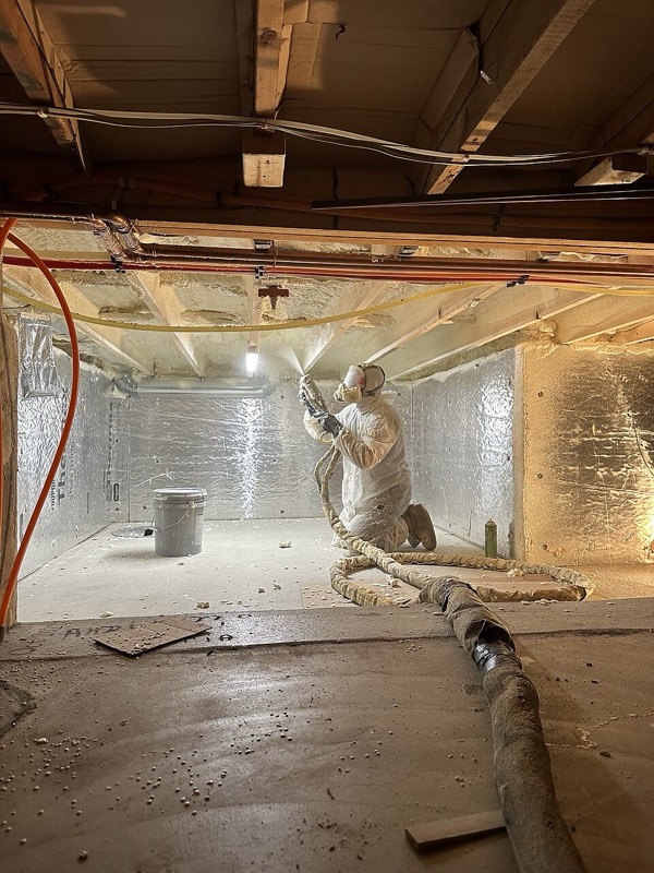 Spray foam insulation applied under a floor